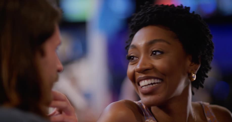 A man and a woman talk and laugh