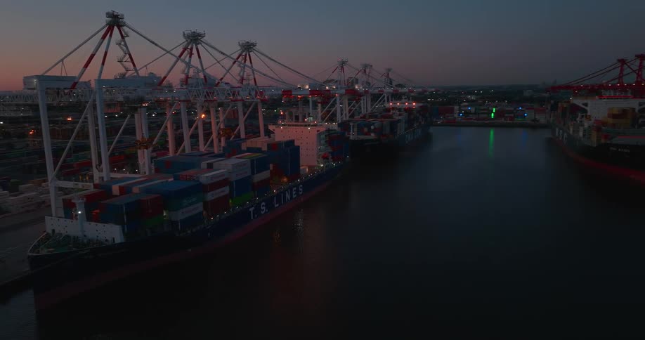 Two large cargo ships with containers in a port