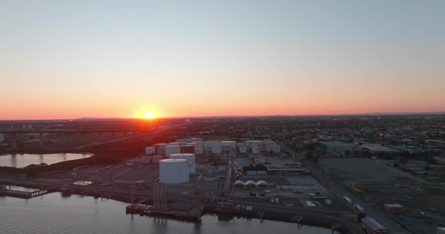 Aerial view of storage silos and connected buildings by the sea shore