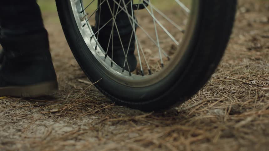 A person spins the back tire of his bicycle