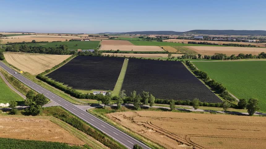 A drone shot of a field of solar panels