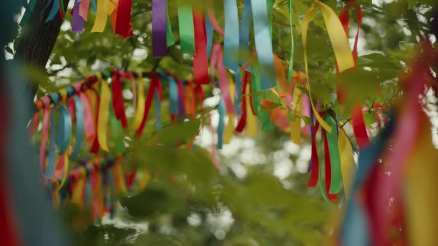 Colorful ribbons tied to tree branches blowing in the breeze