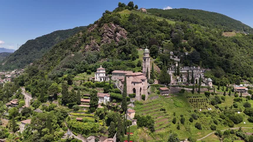 Aerial panorama of medieval buildings amid hills and mountains by the sea