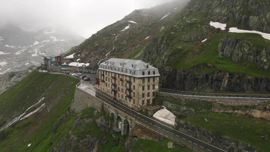 Aerial of a hotel built into a mountain side on a cloudy winter day