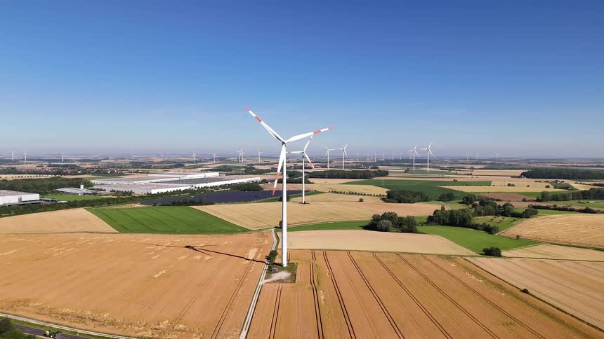 Wind turbines rotate in a field