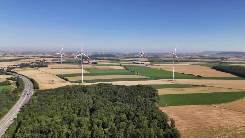 Aerial view of wind power engines in rural fields