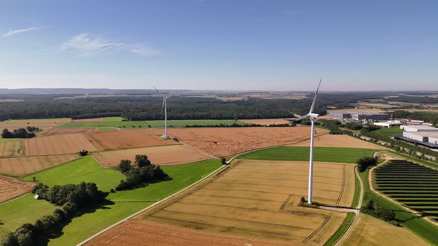 Aerial view of wind energy turbines in agricultural fields