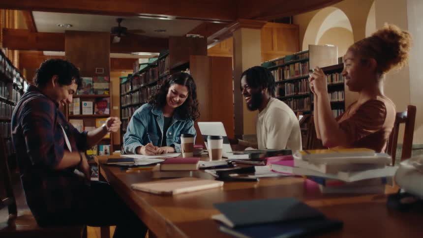 Group of students are laughing and having fun in the library