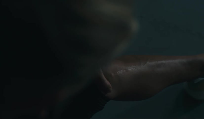 A black woman massages her knee
