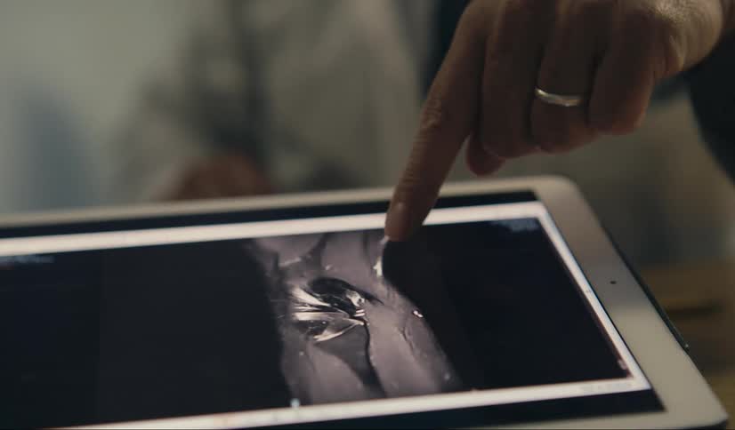 A person plays a video on a tablet