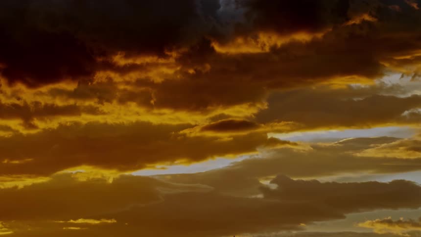 Golden sky with scattered clouds