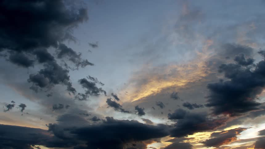 Cloudy sky with rays of sunlight at dawn