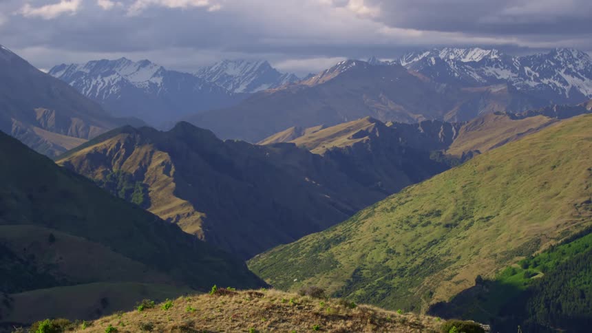 Mountain range with snowcapped peaks on a cloudy day