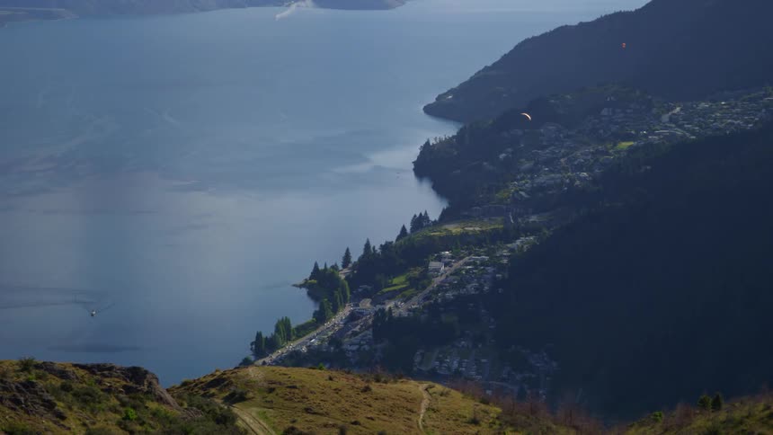 A town sits between the lake and the mountains