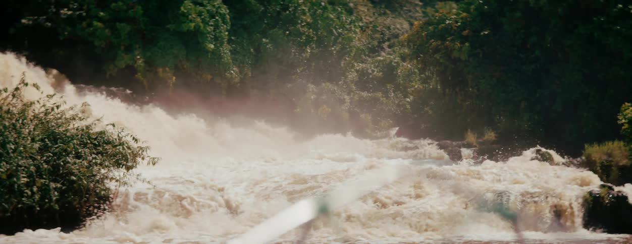Water splashes as rapids flow over rocks
