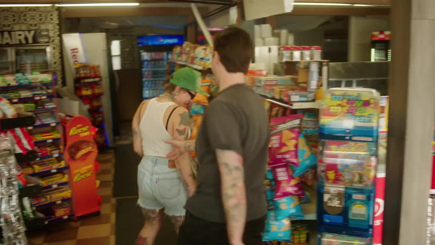 Couple in love walking into a market holding hands and looking happy