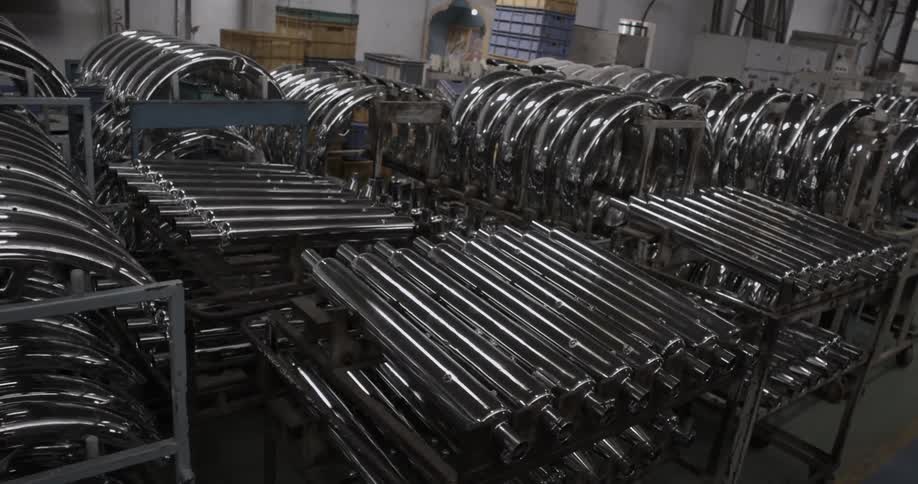 Racks of metal parts that are sitting in a factory type area