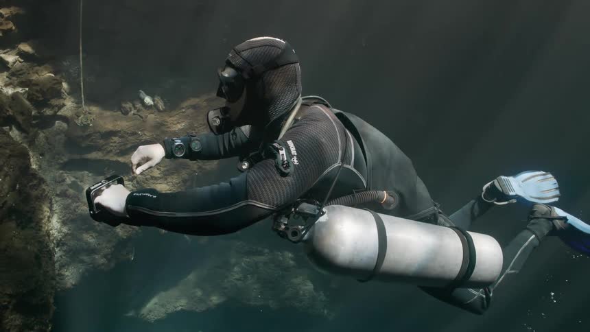 Diver submerged in ocean waters near corals