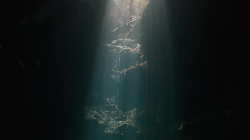 View inside a lake in a cave with sunlight reflection