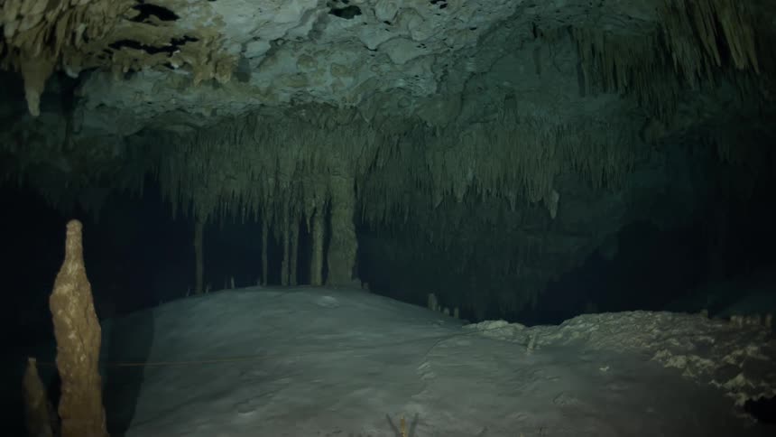 The cave is dark and full of sand