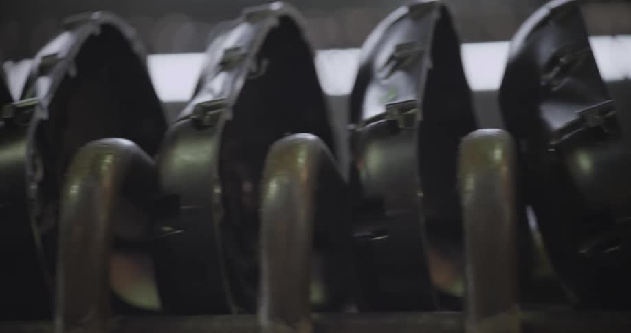 Metal parts are stacked on a shelf