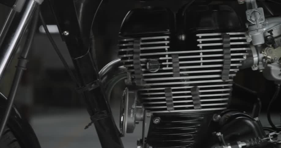 Moving close-up view of a motorcycle and its engine
