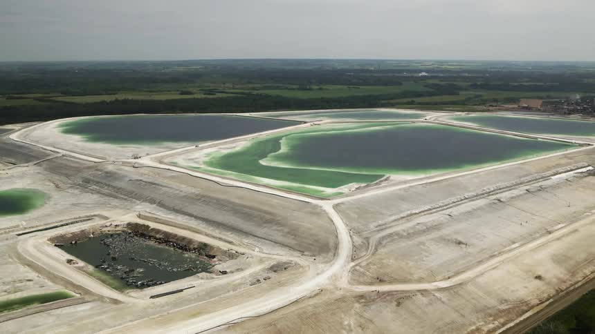 Aerial landscape of industrial waste ponds on grassy plains
