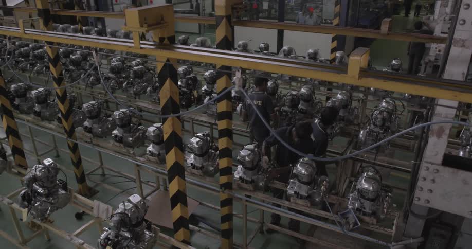 Workers in a factory inspect materials