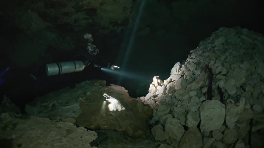Diver inside an aquatic cave having an adventure