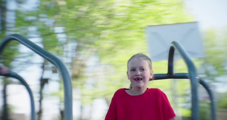 Blonde girl having fun on a spinning toy