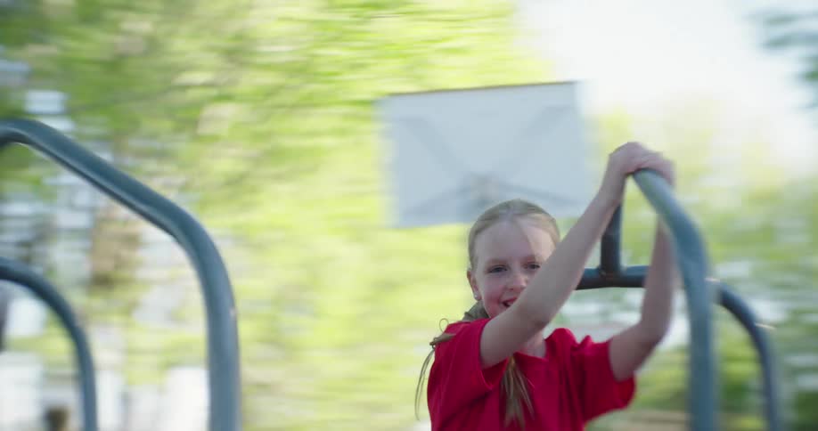 Blonde girl having fun on a spinning toy