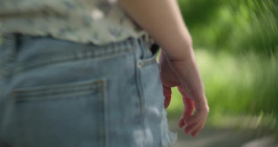 Childs hand in an outdoor environment with sunlight