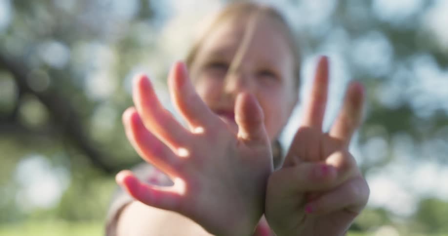 A girl shows her age my showing 7 fingers