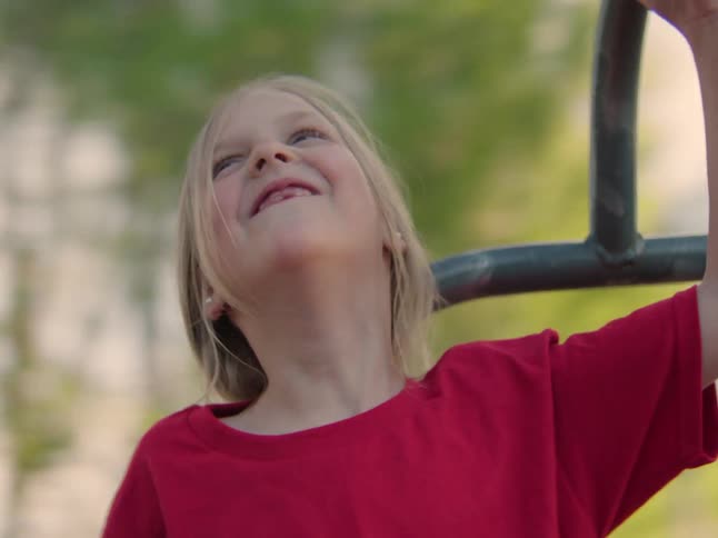Little girl having fun while on a spinning top toy