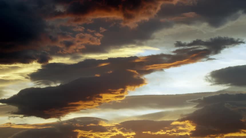 Cloudy sky with a reflection of a golden sun