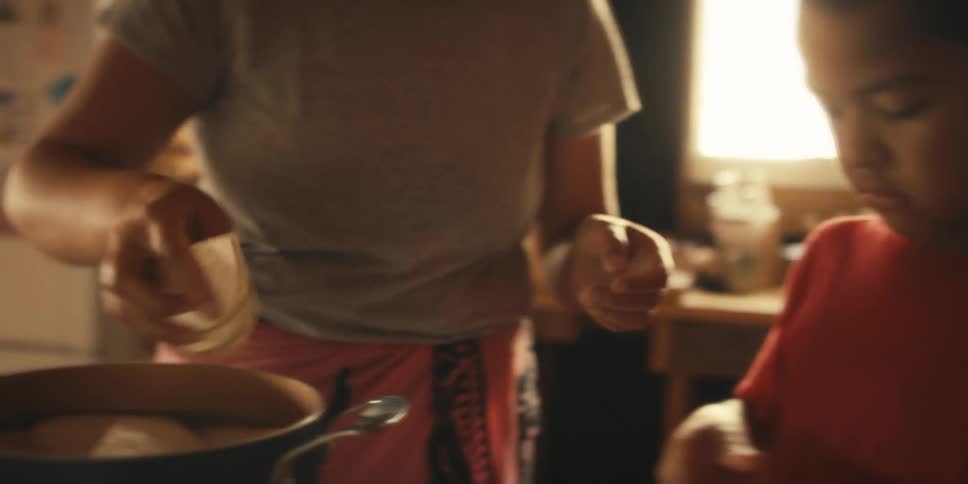 A boy helps his mom cook