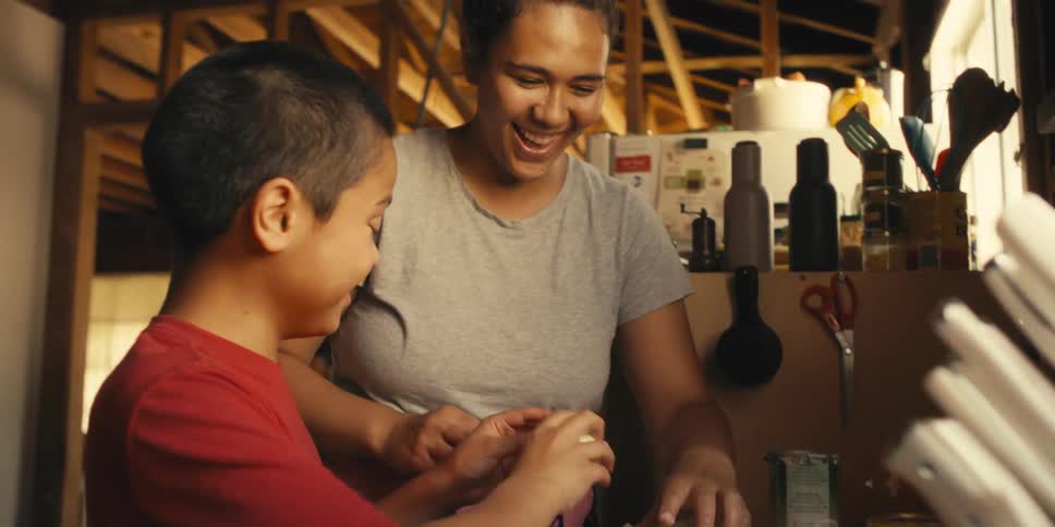 Mother and son cooking together smiling