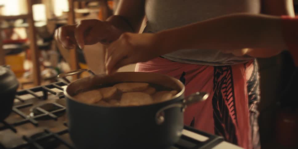A mother and son cook vegetables at home