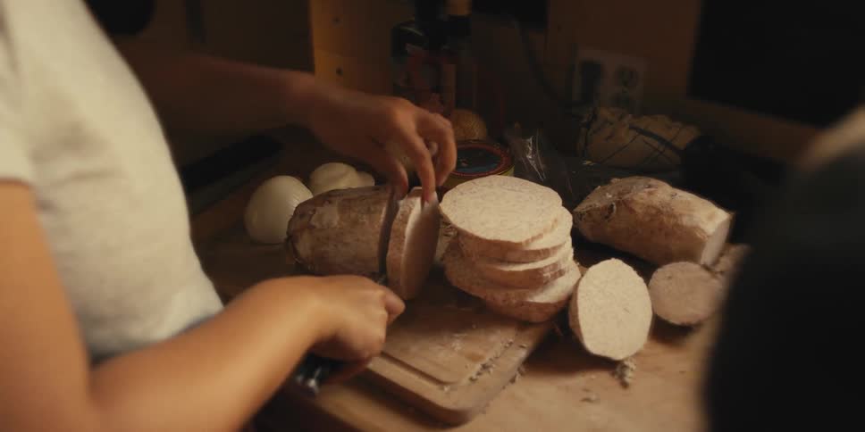 A woman is cutting food at home