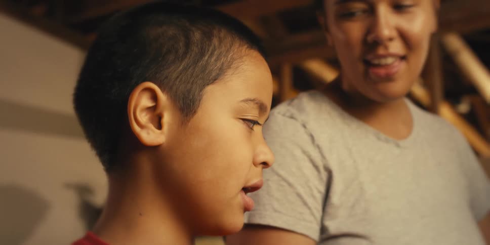 Mother and son sing while working together at home