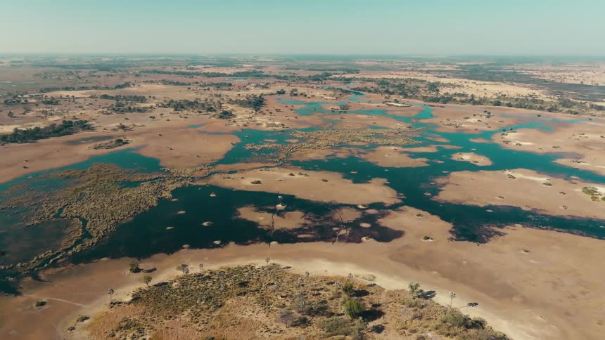 A large plain with pools of interconnected water
