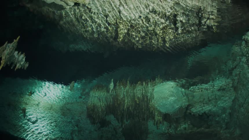 Submerged view of jagged caves and crystal clear waters