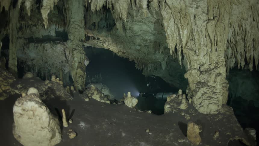 Diver submerged in an aquatic cave
