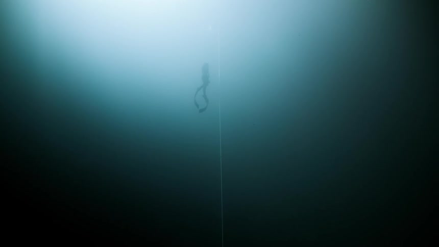 Diver submerged in water rising towards the surface