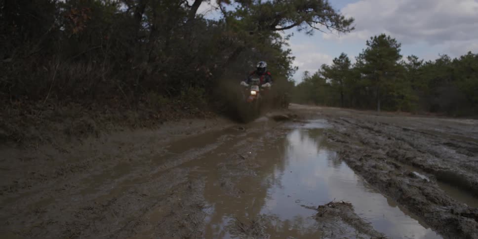 Someone is riding their dirt bike through mud