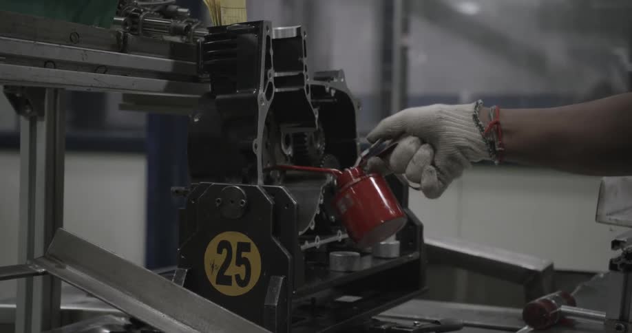 A person oils half a machine