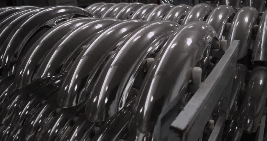 Bicycle mud guards stacked on racks in warehouse