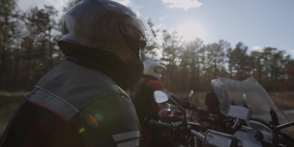 People are on their motorcycles parked