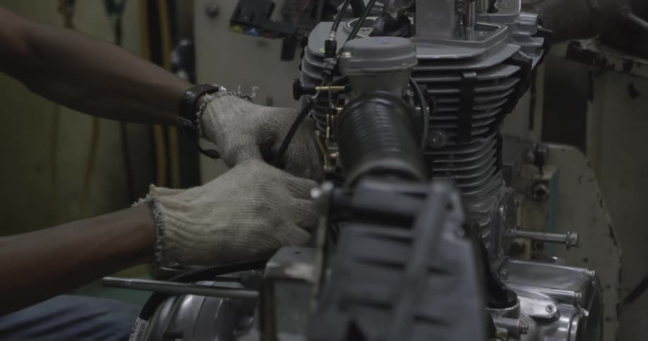 Someone is putting together engine parts
