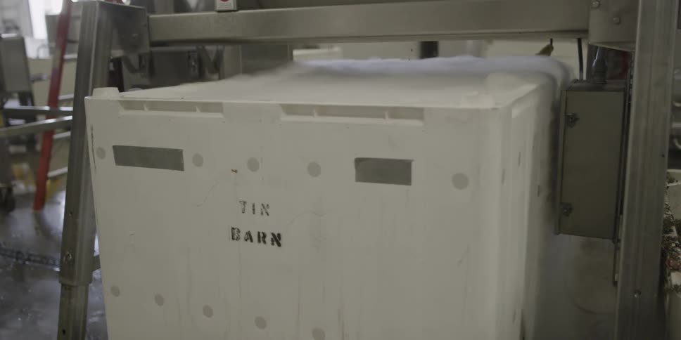 A styrofoam container is being sealed up with dry ice inside